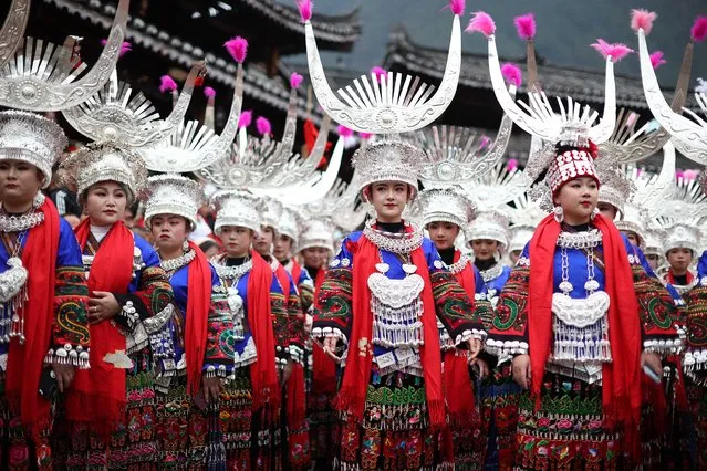 This photo taken on November 19, 2022 shows women of the Miao ethnic minority, dressed in traditional costumes, taking part in the celebration of the Kuzang Festival in Leishan county, in China's southwestern Guizhou province. The Kuzang Festival is an ancestor worship ceremony for the Miao ethnic minority, which is celebrated every 13 years and then held for four consecutive years. (Photo by AFP Photo/China Stringer Network)