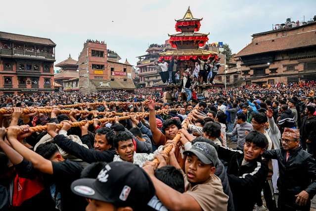 Devotees pull a wooden chariot carrying an idol of the Hindu deity Bhairav during 'Bisket Jatra' festival to mark the Nepali New Year, in Bhaktapur, on the outskirts of Kathmandu, on April 10, 2025. (Photo by Prakash Mathema/AFP Photo)