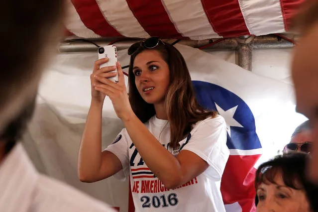 A supporter of Republican presidential nominee Donald Trump uses her phone to photograph Trump during a campaign stop at the Canfield County Fair in Canfield, Ohio, U.S., September 5, 2016. (Photo by Mike Segar/Reuters)
