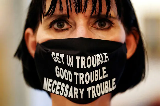 A woman wears a face mask with a quote from the late U.S. Congressman John Lewis, a pioneer of the civil rights movement and long-time member of the U.S. House of Representatives who died July 17, at the Georgia State Capitol building, in Atlanta, Georgia, U.S. July 29, 2020. (Photo by Elijah Nouvelage/Reuters)