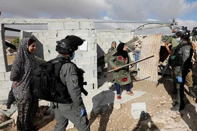 A Palestinian woman argues with Israeli border police officers who arrived to force her stop building a house, in Susya village in the Israeli-occupied West Bank on August 11, 2020. (Photo by Mussa Qawasma/Reuters)