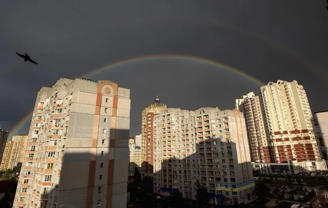 A rainbow appears in the sky, over buildings in Kiev, Ukraine, Saturday, July 11, 2015. (Photo by Evgeniy Maloletka/AP Photo)