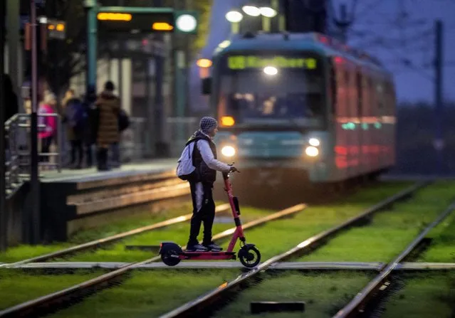 A boy on a scooter crosses rails at a subway station in Frankfurt, Germany, early Monday, December 5, 2022. (Photo by Michael Probst/AP Photo)