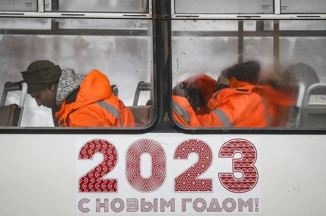 Municipal workers sleep inside a bus in downtown Moscow, Russia, 11 January 2023. Temperatures in Moscow dropped up to -15 degrees Celsius. (Photo by Yuri Kochetkov/EPA/EFE)