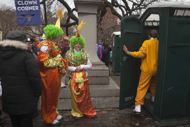 Clowns line up to use a porta-potty as they get ready to participate in the Macy's Thanksgiving Day Parade in New York, November 27, 2014. (Photo by Carlo Allegri/Reuters)