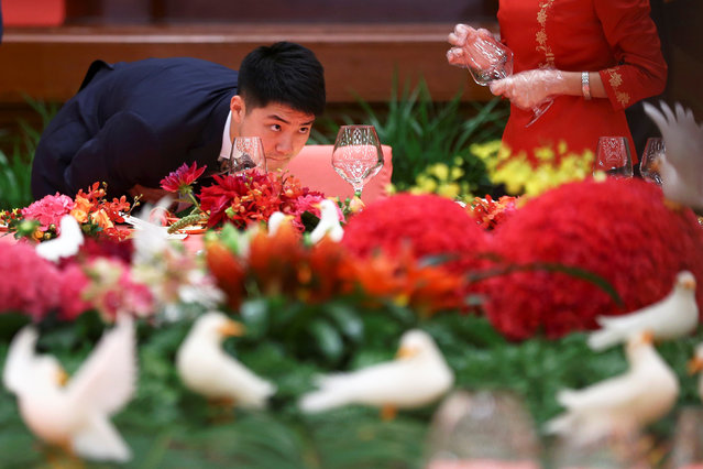 A glass is checked at the table for China's top leaders before the start of a reception to celebrate National Day at the Great Hall of the People in Beijing, China September 30, 2016. (Photo by Damir Sagolj/Reuters)