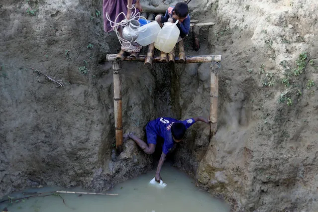 A Rohingya refugee child collects water from a well at the Unchiparang camp near Cox’s Bazar, Bangladesh on January 11, 2018. (Photo by Tyrone Siu/Reuters)