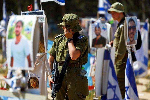 An Israeli soldier reacts at the site of the Nova festival, where people were killed and kidnapped during the October 7 attack by Hamas gunmen from Gaza, amid the ongoing conflict between Israel and the Palestinian Islamist group Hamas, in Reim, southern Israel, on April 1, 2024. (Photo by Hannah McKay/Reuters)