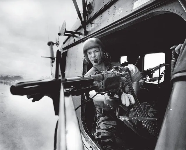 Man your battle stations: The crew chief of helicopter Yankee Papa 13, lance corporal James C. Farley, mans an M-60 machine gun during a mission near Da Nang, Vietnam on March 31, 1965. (Photo by Larry Burrows/Time & Life Pictures)