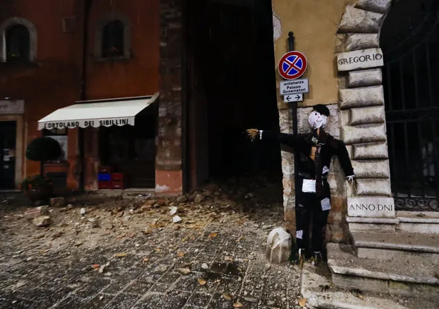 An Halloween dummy rests on a wall in the town of Visso in central Italy, early Thursday, October 27, 2016, after a 5.9 earthquake hit the area. (Photo by Alessandra Tarantino/AP Photo)