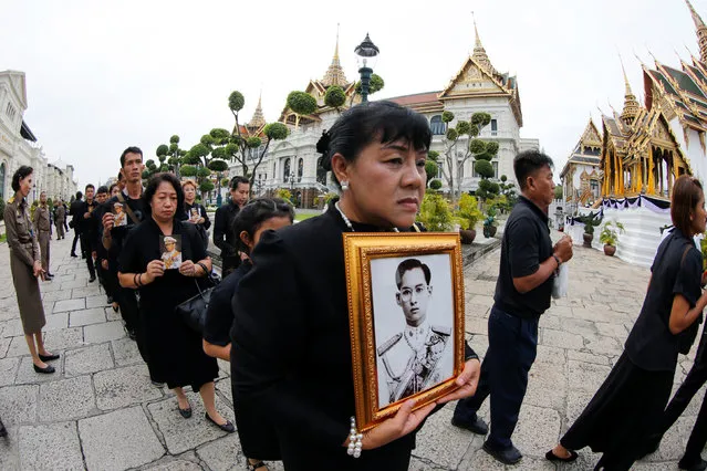 Mourners line up to get into the Throne Hall at the Grand Palace for the first time to pay their respects in front of the golden urn of Thailand's late King Bhumibol Adulyadej in Bangkok, Thailand, October 29, 2016. (Photo by Jorge Silva/Reuters)