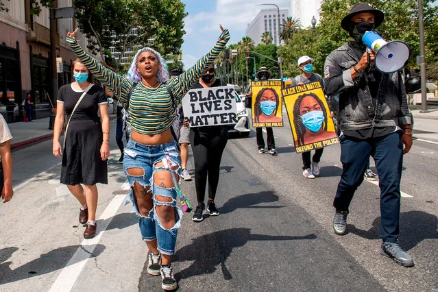 Paris (2nd L), an activist from “Active Advocate”, and others march during a Black Livers Matter protest, June 29, 2020, in downtown Los Angeles, California. (Photo by Valérie Macon/AFP Photo)