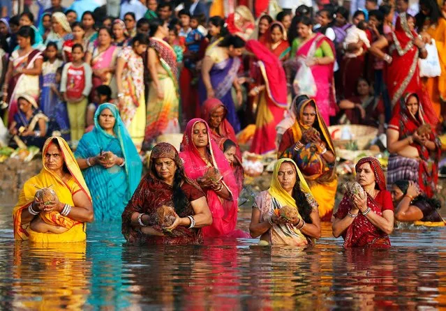 Hindu devotees worship the Sun god in the waters of the Sabarmati river during the religious festival of Chhat Puja in Ahmedabad, India, November 6, 2016. (Photo by Amit Dave/Reuters)