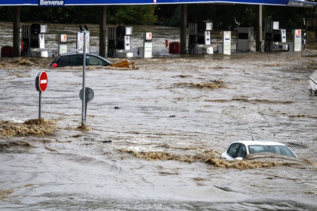 This photograph taken on October 17, 2024, shows cars are submerged in a commercial zone on October 16, 2024, in Givors, central-eastern France, following heavy rainfall in the area, which is under a red alert for rain and flooding. (Photo by Jean-Philippe Ksiazek/AFP Photo)