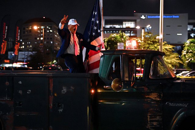 A supporter of former President Donald Trump gestures from a truck outside of the Versailles restaurant in Miami on Tuesday, November 5, 2024. (Photo by Silvio Campos/AFP Photo)