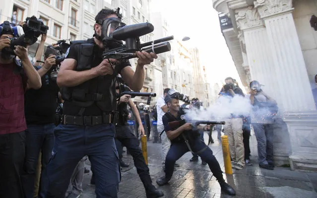 Police fire tear gas against protesters during clashes in Istanbul, Turkey, Monday, July 8, 2013. (Photo by Vadim Ghirda/AP Photo)