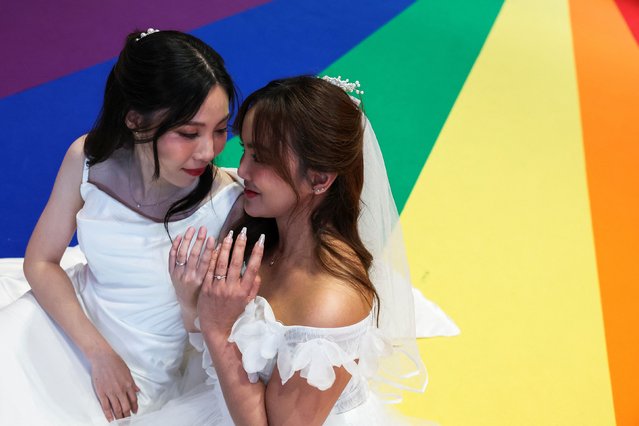 A lesbian couple Natnicha Somparn, 31, and Sorsomrudee Thippayatum, 32, pose for a picture as they celebrate after recieving official marriage certificates, as the country's marriage equality bill comes into effect following a royal endorsement which effectively makes Thailand Asia's third territory to legalise same-sеx unions, in Bangkok, Thailand, on January 23, 2025. (Photo by Chalinee Thirasupa/Reuters)