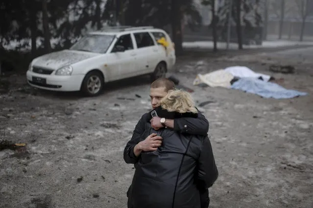 A rebel comforts a wife of a killed civilian in shelling in Donetsk, eastern Ukraine, Friday, January 30, 2015. (Photo by Vadim Braydov/AP Photo)
