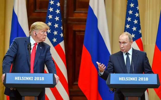 US President Donald Trump (L) listens as Russia's President Vladimir Putin speaks during a joint press conference after a meeting at the Presidential Palace in Helsinki, on July 16, 2018. (Photo by Yuri Kadobnov/AFP Photo)