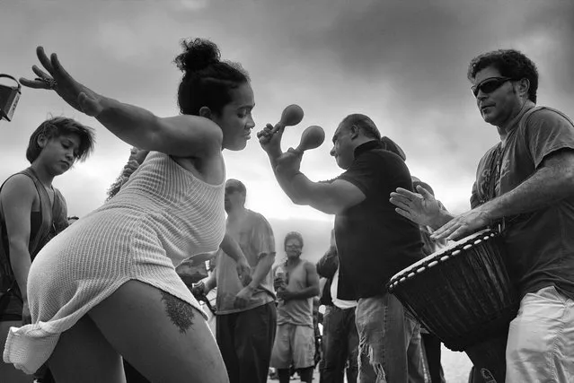 A young woman dances to the entrancing rhythms at the Venice Beach Drum Circle, as the sun sets over the ocean on a warm summer evening. (Photo by Dotan Saguy)