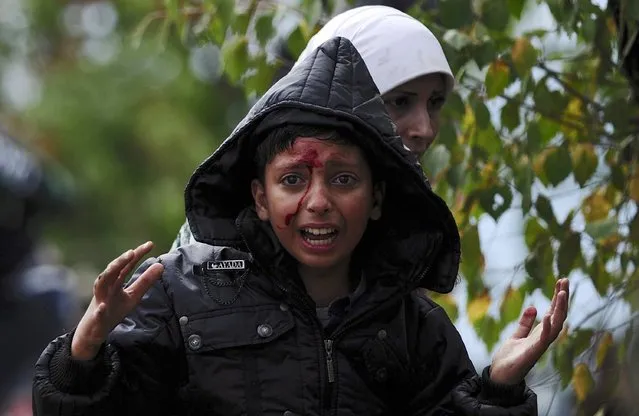 A girl cries after crossing Greece's border into Macedonia near Gevgelija, Macedonia, August 22, 2015. (Photo by Ognen Teofilovski/Reuters)