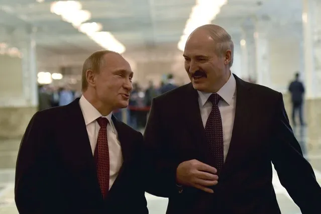 Russia's President Vladimir Putin (L) reacts as he talks to Belarus' President Alexander Lukashenko before a meeting on resolving the Ukrainian crisis in Minsk, February 11, 2015. (Photo by Mykola Lazarenko/Reuters)