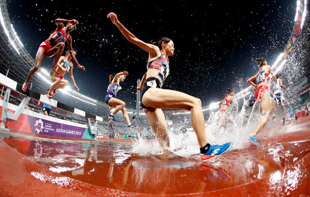 Athletes compete in the final of the women' s 3000 m steeplechase athletics event during the 2018 Asian Games in Jakarta on August 27, 2018. (Photo by Issei Kato/Reuters)