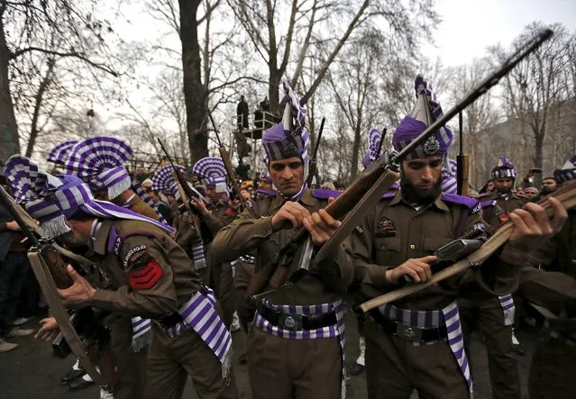 Indian policemen get ready to give a gun salute during the funeral of the chief minister of Jammu and Kashmir Mufti Mohammad Sayeed in Srinagar, January 7, 2016. The leader of India's insurgency-plagued Jammu and Kashmir state and an ally of Prime Minister Narendra Modi died on Thursday, bringing political uncertainty to the disputed region at the heart of tension between India and Pakistan. Sayeed, 79, died of a respiratory infection after spending the last two weeks in hospital in New Delhi, a spokesman for his Peoples Democratic Party (PDP) said. (Photo by Danish Ismail/Reuters)