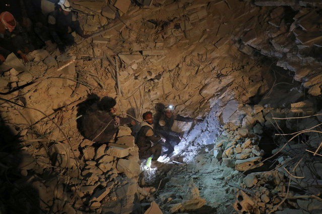 Civil defence members work at a site hit at night by an airstrike in Saraqeb, in rebel-held Idlib province, Syria December 11, 2016. (Photo by Ammar Abdullah/Reuters)