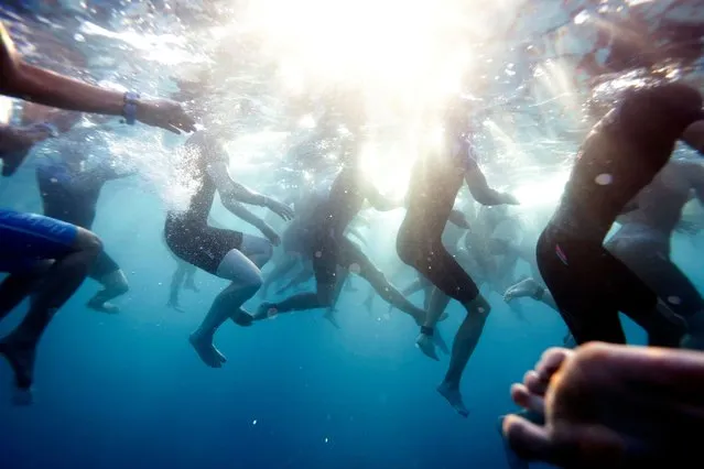 Athletes wait in the water to start the swim portion during the VinFast IRONMAN World Championship on October 14, 2023 in Kailua Kona, Hawaii. (Photo by Sean M. Haffey/Getty Images for IRONMAN)