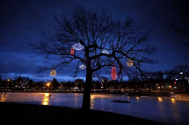 A skater races around on the ice at Deering Oaks Park, Wednesday evening, December 28, 2016, in Portland, Maine. Weather more favorable to skiers will move in on Thursday as a winter snow storm is expected to move through the region. (Photo by Robert F. Bukaty/AP Photo)