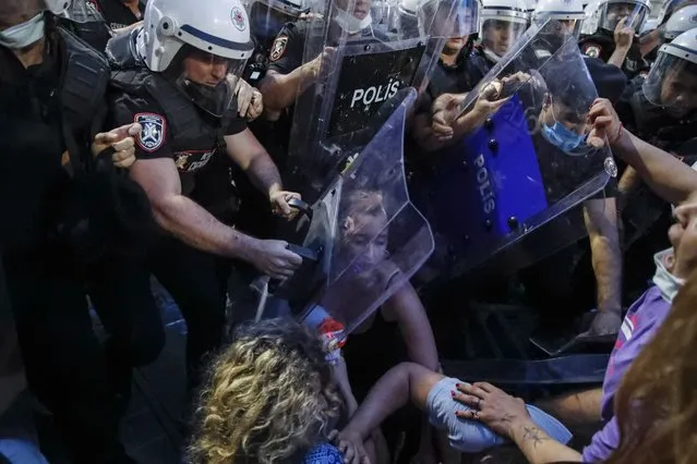 Protesters clash with police officers preventing them from marching against the government's decision to withdraw from Istanbul Convention, in Istanbul, Thursday, July 1, 2021. Turkey formally withdrew Thursday from a landmark international treaty protecting women from violence, and signed in its own city of Istanbul, though President Recep Tayyip Erdogan insisted it won’t be a step backwards for women. Hundreds of women demonstrated in Istanbul later Thursday, holding banners that said they won't give up on the Council of Europe’s Istanbul Convention. (Photo by Kemal Aslan/AP Photo)