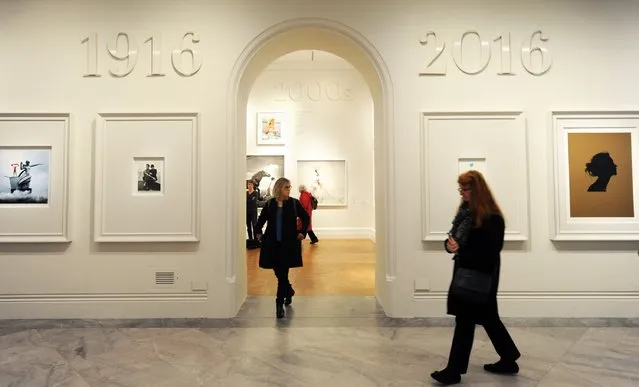 Journalists attend the press preview for “Vogue 100: A Century of Style” exhibiting the photographs that has been commissioned by British Vogue since it was founded in 1916 at National Portrait Gallery on February 10, 2016 in London, England. (Photo by Stuart C. Wilson/Getty Images)