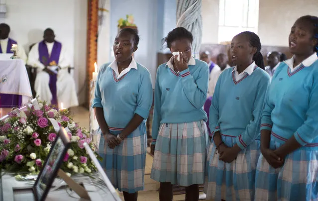 A schoolgirl from the Karima Girls School dramatic society sheds a tear after they sang tribute songs for 22-year-old business management student Angela Nyokabi Githakwa, who previously went to the school and was killed in the Garissa University College attack and known to her friends as “Jojo”, during the funeral service in the village of Mutunguru, Kenya Friday, April 10, 2015. (Photo by Ben Curtis/AP Photo)