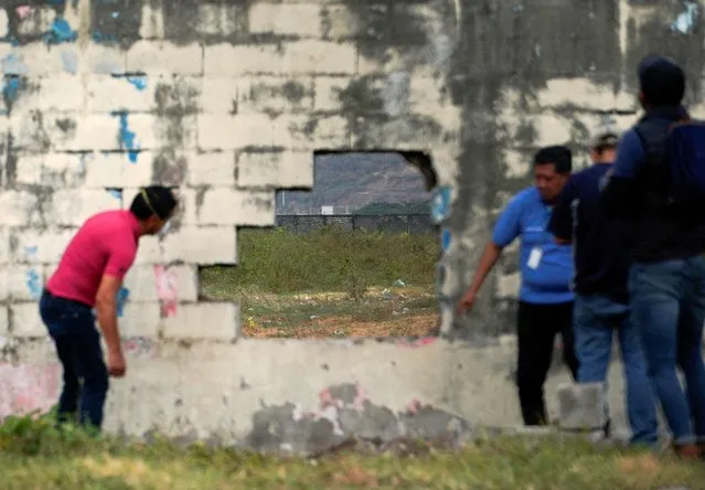 Personnel from the prison inspect a hole in the wall after several inmates were killed in fights between gangs, in Guayaquil, Ecuador on November 2, 2022. (Photo by Santiago Arcos/Reuters)