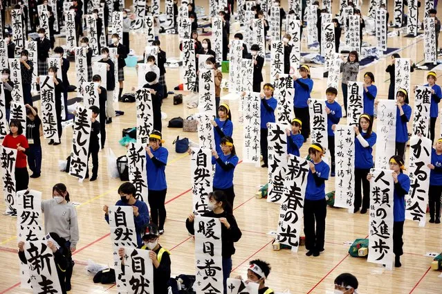 Participants show off their writings in a New Year calligraphy contest at Nippon Budokan in Tokyo, Japan on January 5, 2024. (Photo by Issei Kato/Reuters)