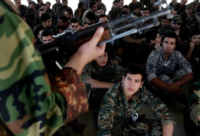 In this Thursday, September 19, 2013 photo, members of the Basij paramilitary militia listen to their trainer during a training session in Tehran, Iran. (Photo by Ebrahim Noroozi/AP Photo)