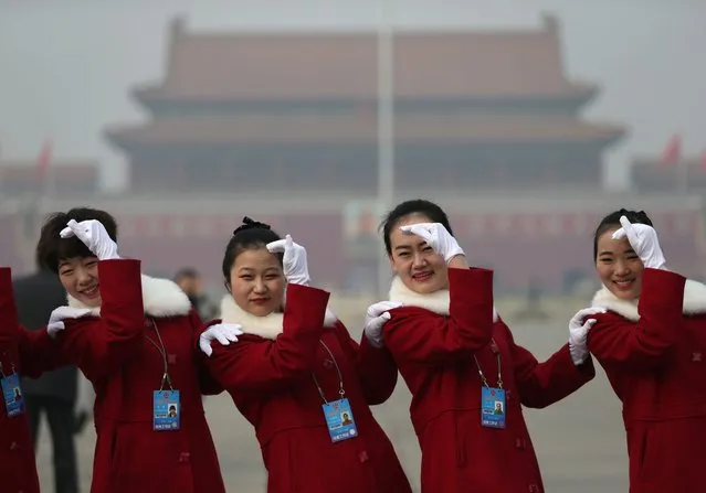 Chinese hostesses pose for a photo on Tiananmen Square before the opening of the Fourth Session of the 12th National Committee of the Chinese People's Political Consultative Conference (CPPCC) at the Great Hall of the People (GHOP) in Beijing, China, 03 March 2016. The CPPCC is the top advisory body of the Chinese political system and runs alongside the annual plenary meetings of the 12th National People's Congress (NPC), together known as “Lianghui” or “Two Meetings”. (Photo by How Hwee Young/EPA)