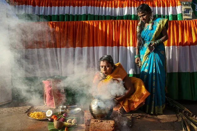 Tamilian women cook pongal, a traditional rice dish, during the Thai Pongal festival celebration in Mumbai, India, 15 January 2024. Pongal, very popular in South Indian states, is a famous dish made of rice boiled in milk with jaggery and other sweeteners. Thai Pongal is a famous harvest festival celebrated by Tamilians all across the world, widely celebrated on 15 January. The significance is the offering of thanks to the sun and weather for helping obtain a bountiful harvest. (Photo by Divyakant Solanki/EPA)