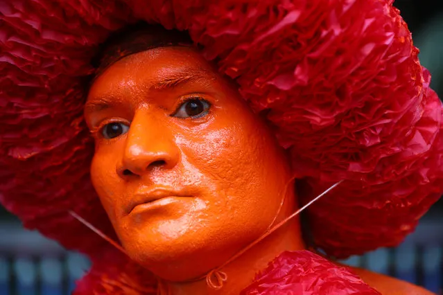 A Hindu devotee displays colour applied on his face as he celebrates Lal Kach festival in Munshiganj, Bangladesh on April 13, 2019. (Photo by Mohammad Ponir Hossain/Reuters)