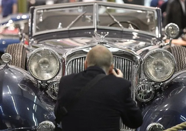 A visitor takes a picture of a classic Horch 853 cabriolet at the world show for vintage, classic and prestige cars Techno Classica in Essen, Germany, Friday, April 8, 2016. (Photo by Martin Meissner/AP Photo)