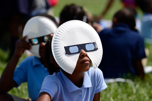 Students at the Jennings School District view the solar eclipse with glasses donated by Mastercard on August 21, 2017 in St Louis, Missouri. (Photo by Jeff Curry/Getty Images for Mastercard)