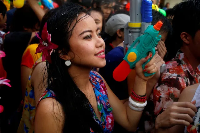 A reveller reacts during a water fight at Songkran Festival celebrations in Bangkok April 13, 2016. (Photo by Jorge Silva/Reuters)