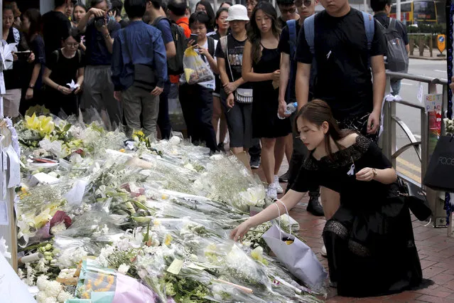 Mourners stop by a makeshift memorial, to lay flowers and pray for a man who fell to his death Saturday after hanging a protest banner against an extradition bill in Hong Kong Sunday, June 16, 2019. Tens of thousands of Hong Kong residents, mostly in black, have jammed the city’s streets Sunday to protest the government’s handling of a proposed extradition bill. (Photo by Kin Cheung/AP Photo)
