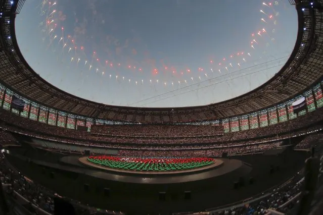 Fireworks explode over the stadium as actors perform, during the opening ceremony of the 2015 European Games in Baku, Azerbaijan, Friday, June 12, 2015. (AP Photo/Dmitry Lovetsky)