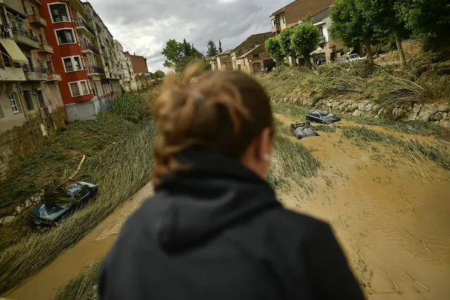 Cars are partially submerged in a flooded area in Tafalla, northern Spain, Tuesday, July 9, 2019. Authorities in northern Spain say firefighters have found the body of a driver whose car was dragged on Monday evening amid flash flooding caused by intense and sudden downpours. (Photo by Alvaro Barrientos/AP Photo)