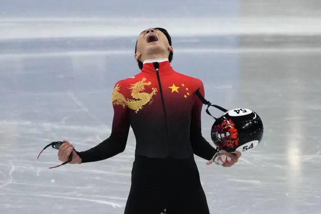 Ren Ziwei of China, celebrates after winning the men's 1,000-meter final during the short track speedskating competition at the 2022 Winter Olympics, Monday, February 7, 2022, in Beijing. (Photo by Natacha Pisarenko/AP Photo)