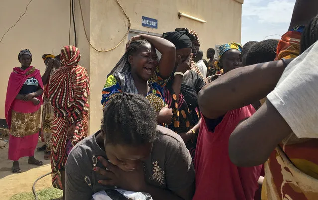Relatives of the six aid workers who were ambushed and killed grieve as they wait to collect and bury the bodies of their loved ones, outside the morgue in Juba, South Sudan Monday, March 27, 2017. The ambush of the six aid workers took place Saturday on the road from Juba, the capital, to Pibor, and is the latest of several attacks on aid workers in the country where at least 12 aid workers have been killed so far this year and 79 since civil war began in 2013. (Photo by AP Photo/Stringer)