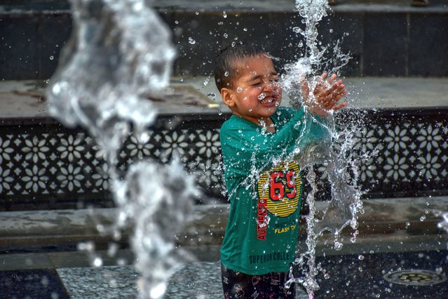 A boy seen cooling off with fountain water on a scorching summer day on May 28, 2024. Kashmir valley experienced a significant rise in temperatures with several areas recording the highest temperatures in decades. The Meteorological Department predicted the continuation of the heatwave in the next month too. (Photo by Saqib Majeed/SOPA Images/Rex Features/Shutterstock)