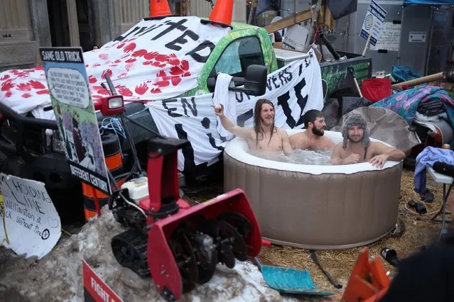 Protestors, participating in a blockade of downtown streets near the parliament building, enjoy a dip in a portable hot tub as a demonstration led by truck drivers opposing vaccine mandates continues on February 16, 2022 in Ottawa, Ontario, Canada Prime Minister Justin Trudeau has invoked the Emergencies Act for the first time in Canada's history to try to put an end to the blockade which is now in it's third week. (Photo by Scott Olson/Getty Images)